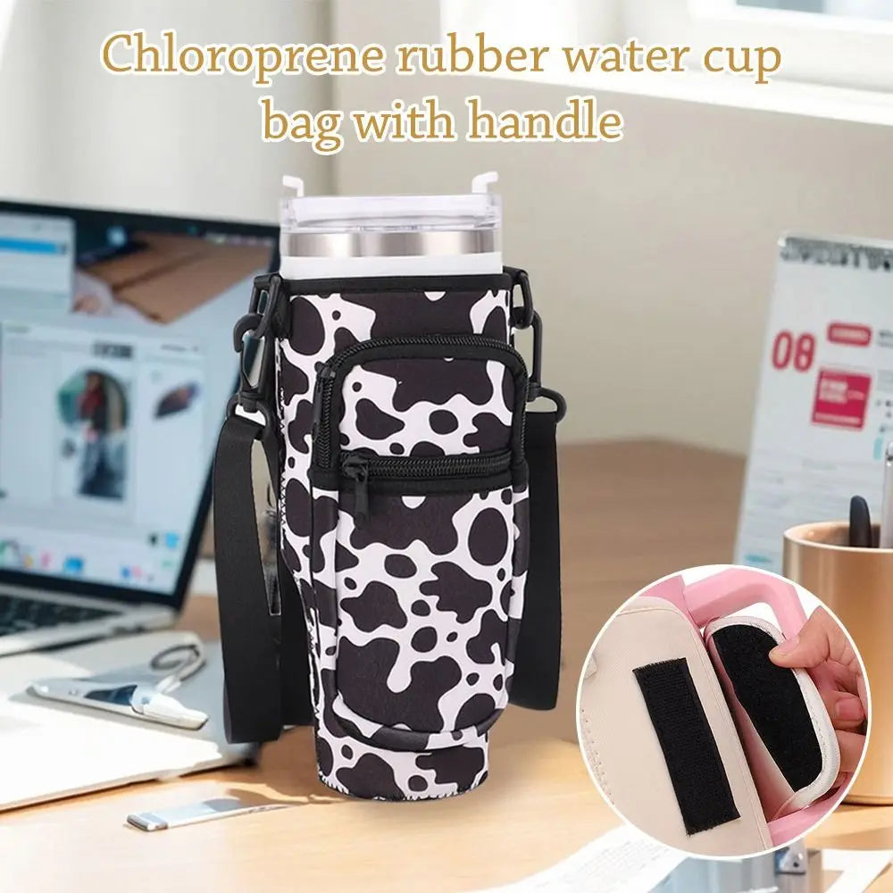 A black and white chloroprene rubber water cup bag with a handle is shown on a desk next to a laptop.