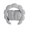 A gray microfiber skincare headband and wristband set with a floral design.