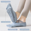 A pair of light blue five-finger yoga socks shown on a foot, highlighting the bonding design and anti-slip granules.