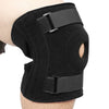 Black open-back knee brace with side stabilizers worn on a person's leg.