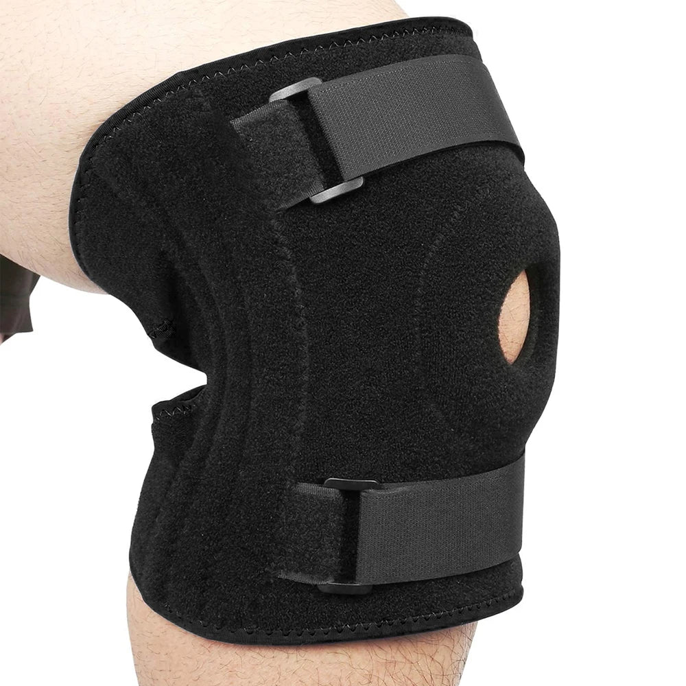 Black open-back knee brace with side stabilizers worn on a person's leg.