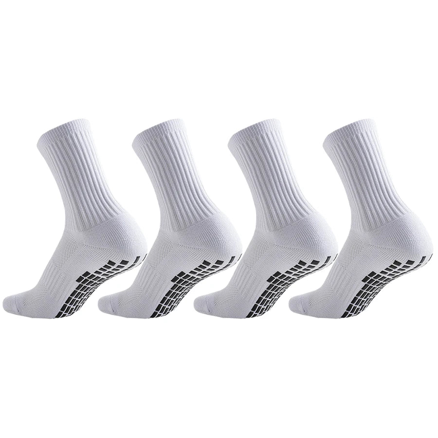 A set of white athletic grip socks shown from the side, featuring a textured pattern on the sole.