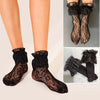 Schwarze florale Spitzen-Wadenstrümpfe auf den Beinen und im Detail.