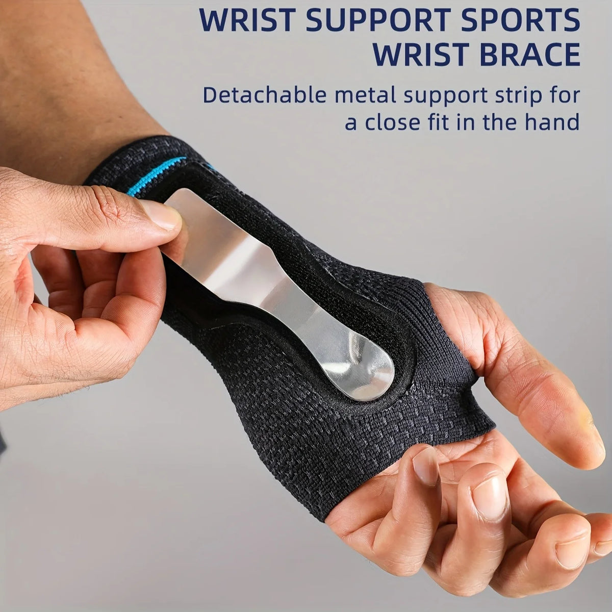 A hand is wearing a black wrist support sports wrist brace with a detachable metal strip for hand support.