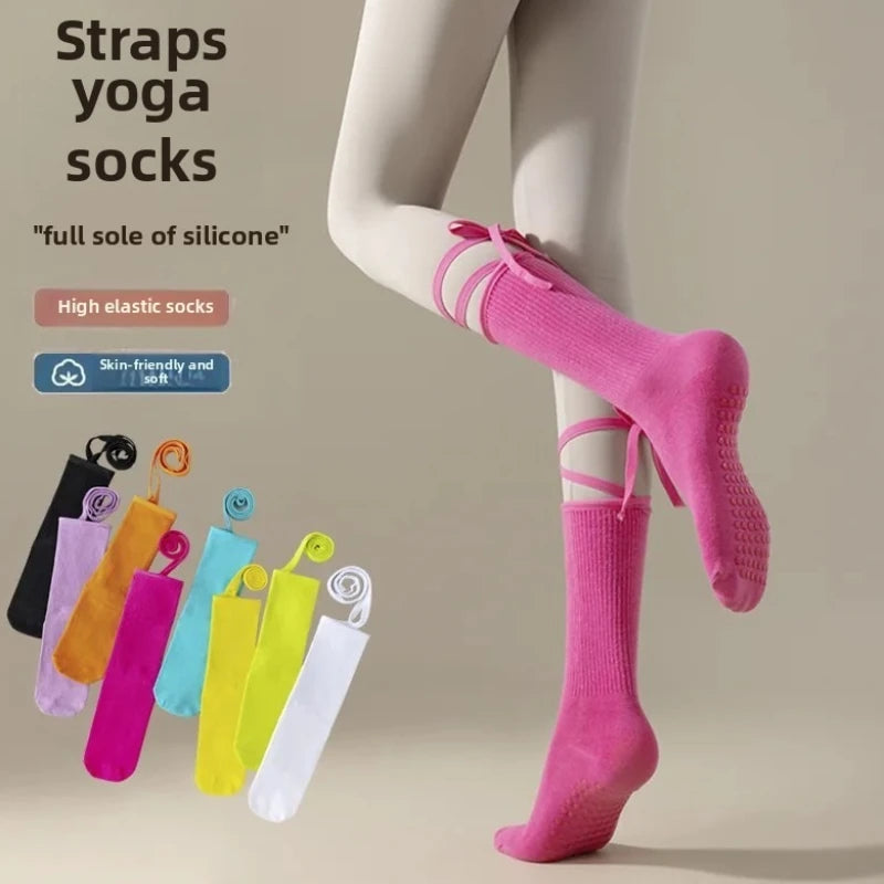 A model is wearing bright pink elastic yoga socks with a full sole of silicone