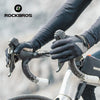 A hand wearing black cycling gloves is gripping the handlebars of a bicycle or motorcycle.
