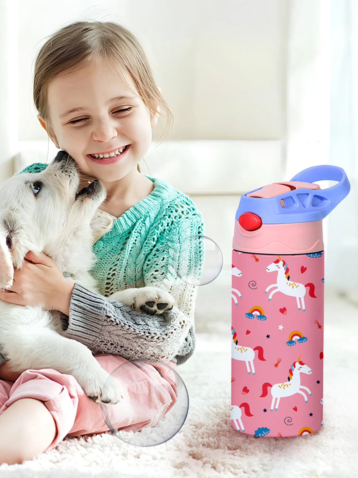 A smiling girl holds a white dog while a pink insulated stainless steel thermos cup stands beside them.