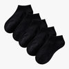 A stack of black thin ankle socks laid out flat.