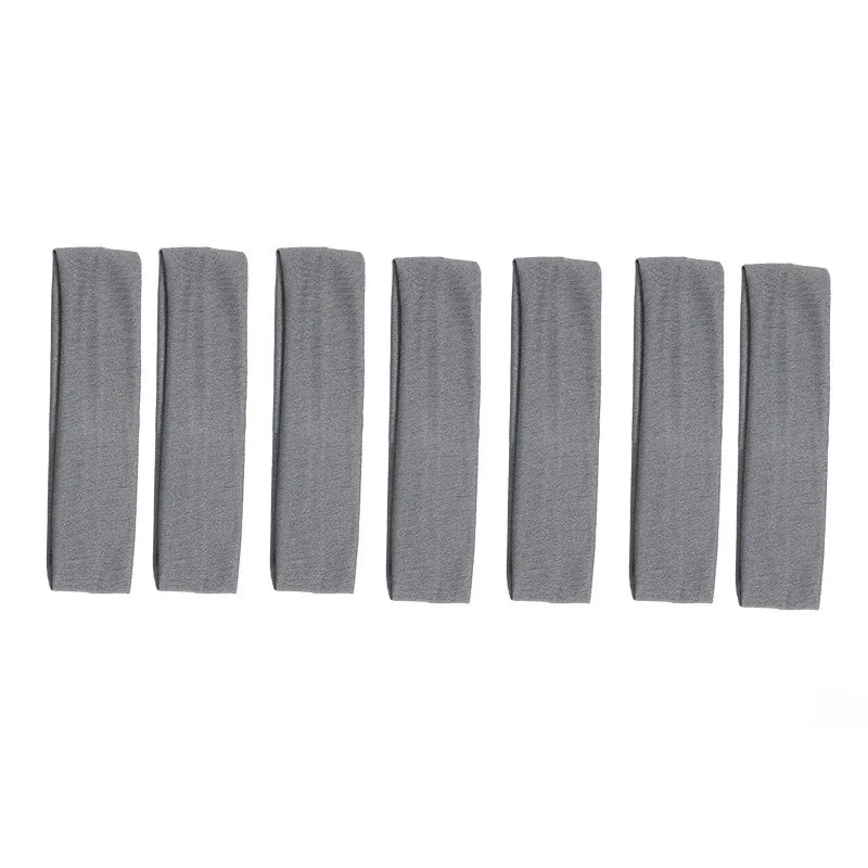 A set of solid gray elastic hair bands arranged in a row.