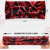 A black elastic sports headband with a red, intricate root pattern is shown being stretched on a hand.