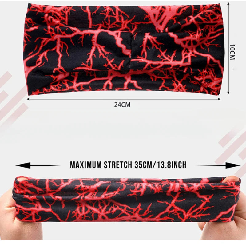 A black elastic sports headband with a red, intricate root pattern is shown being stretched on a hand.