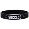 Black silicone wristband with the word SUCCESS printed in white text and gold arrows.