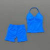 A bright blue women's seamless backless fitness set consisting of a cropped top and matching shorts.
