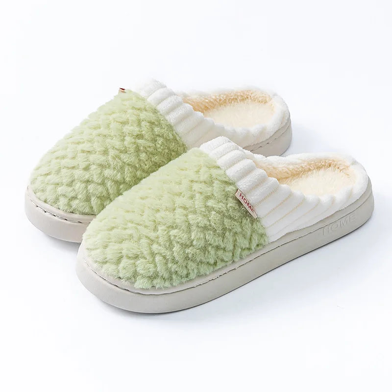 A pair of light green plush fleece slippers with white trim and soles.