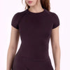 A dark plum performance fitness short sleeve top for women shown on a model.