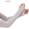 Grey UV protection cooling arm sleeves being worn on a person's arm.