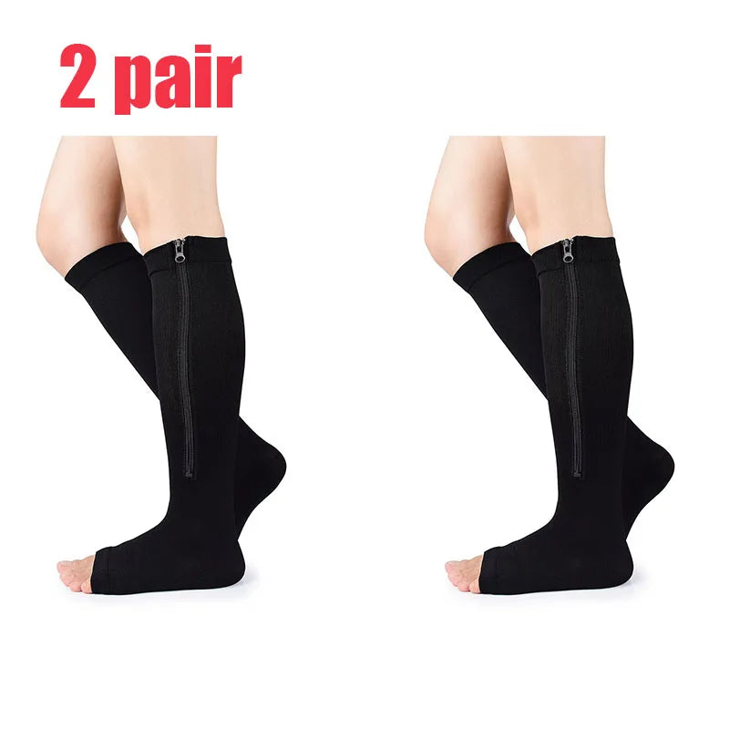 A pair of black compression zippered stockings shown on a model's legs.