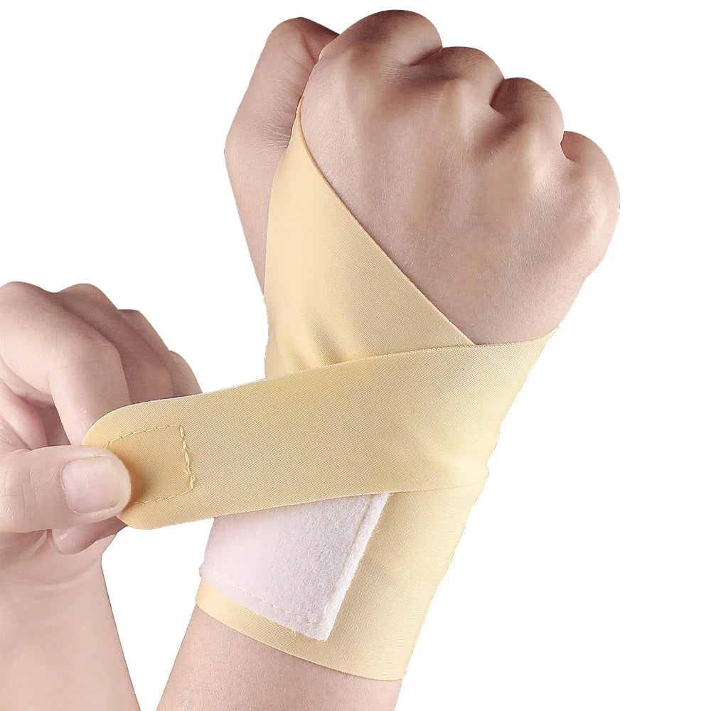 A hand is wearing a beige wrist support compression strap on its forearm.