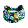 A floral patterned bohemian cotton stretch headband in navy blue, teal, and yellow.
