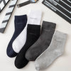 A collection of five bamboo fiber socks in black, white, and gray are displayed on a light surface.