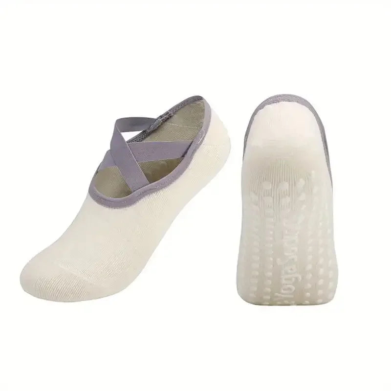 A pair of beige silicone anti-slip socks designed for Pilates and yoga