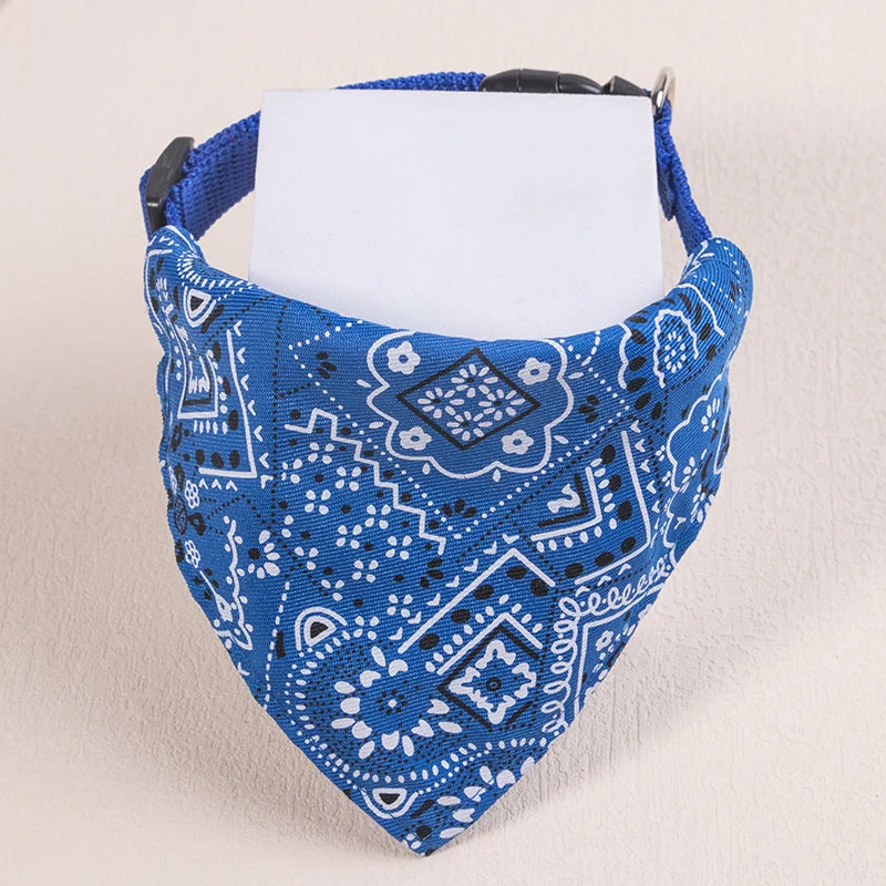 A blue patterned fabric bandana with a white tag is displayed against a light background.