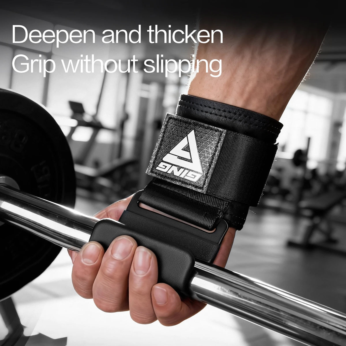 A hand grips a chrome barbell with a black wrist wrap featuring a triangular grip for heavy weight lifting.