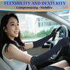 A woman wearing black compression gloves is driving a car, demonstrating flexibility and dexterity.