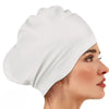 A white silicone swim cap is shown on a woman's head, highlighting its smooth texture and fit.