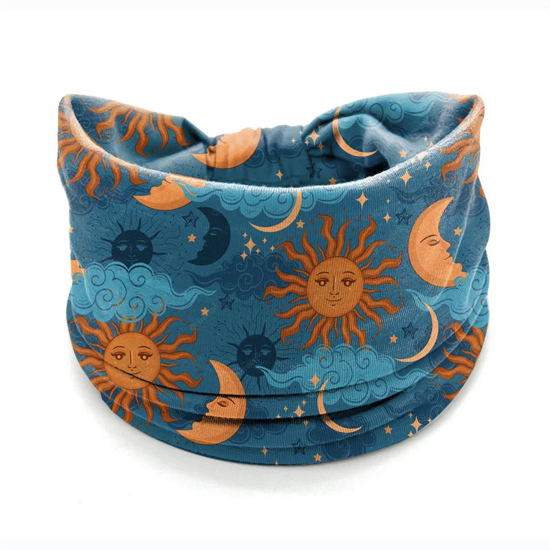 A bohemian stretch cotton headband featuring a celestial design with orange and blue tones of the sun and moon.