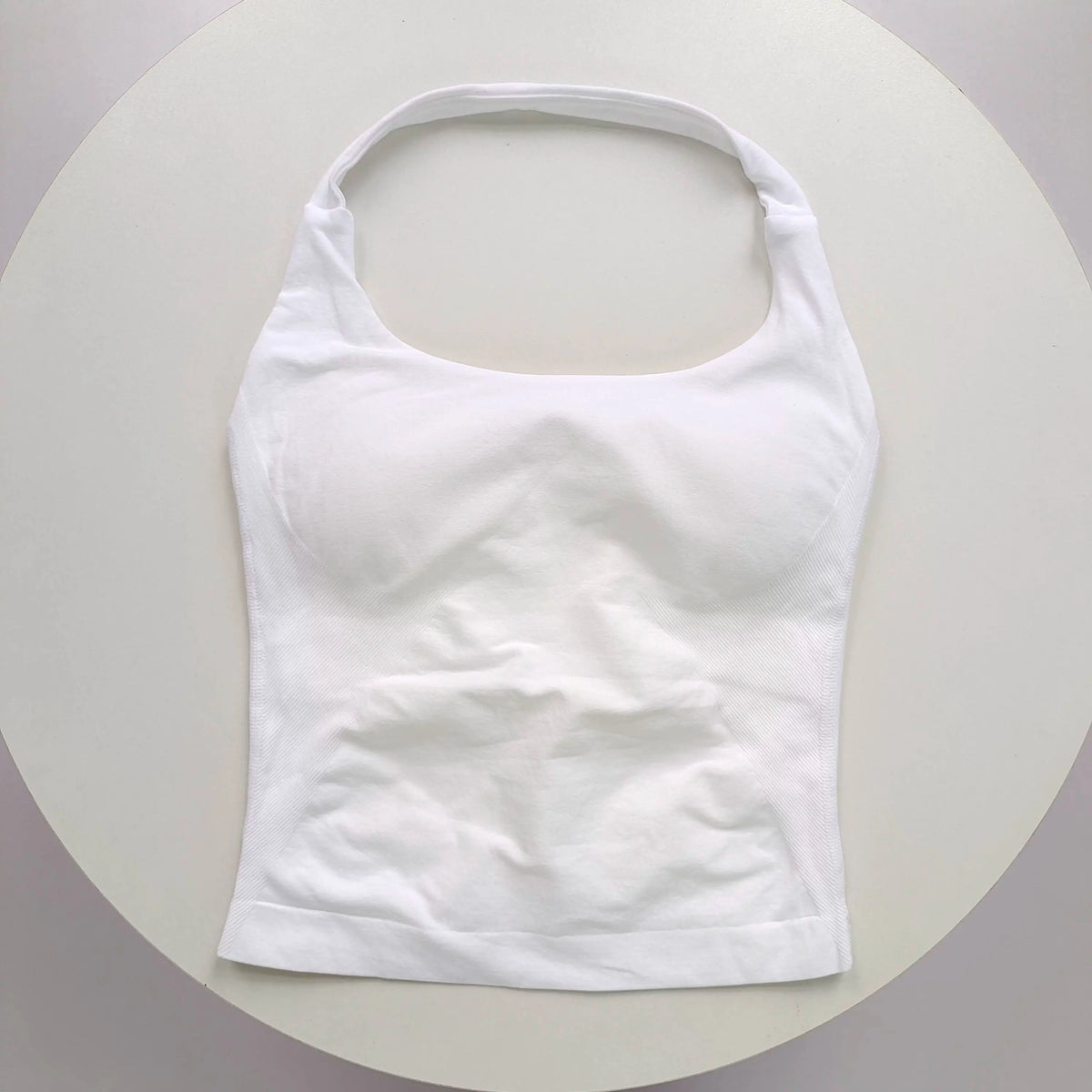 White seamless sports camisole top shown against a light background.