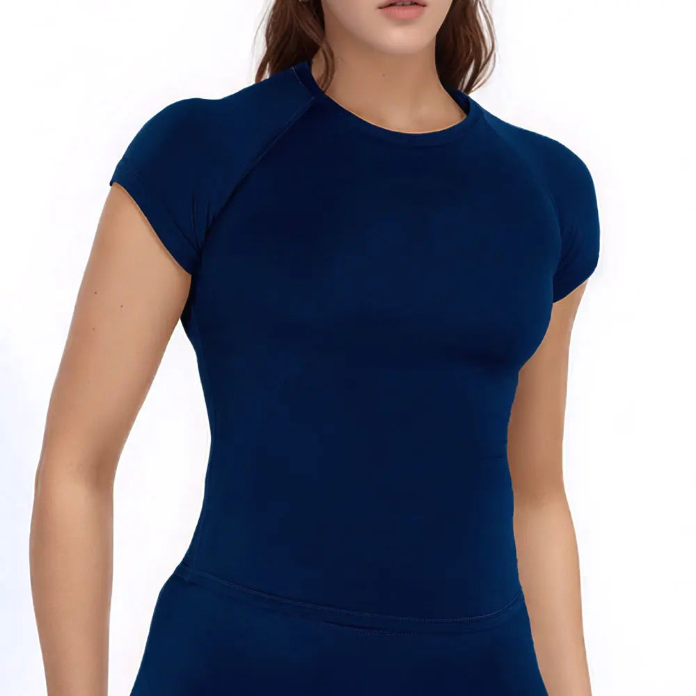 A navy blue performance fitness short sleeve top for women shown on a model.