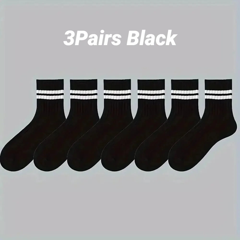 Three pairs of black casual striped men's socks laid out horizontally.