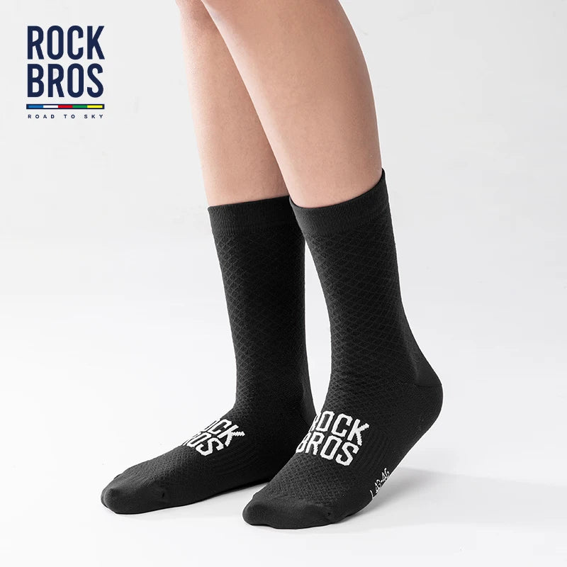 A pair of black Rock Bros high elastic cycling and hiking socks shown on a person's leg.