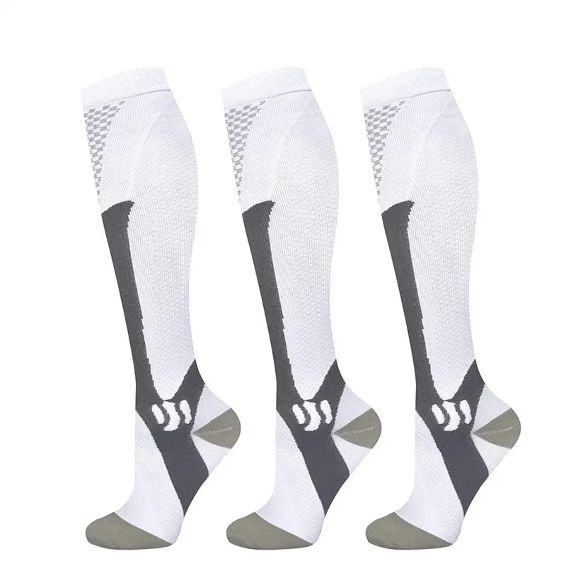 Three pairs of white compression socks with black stripes and gray soles.