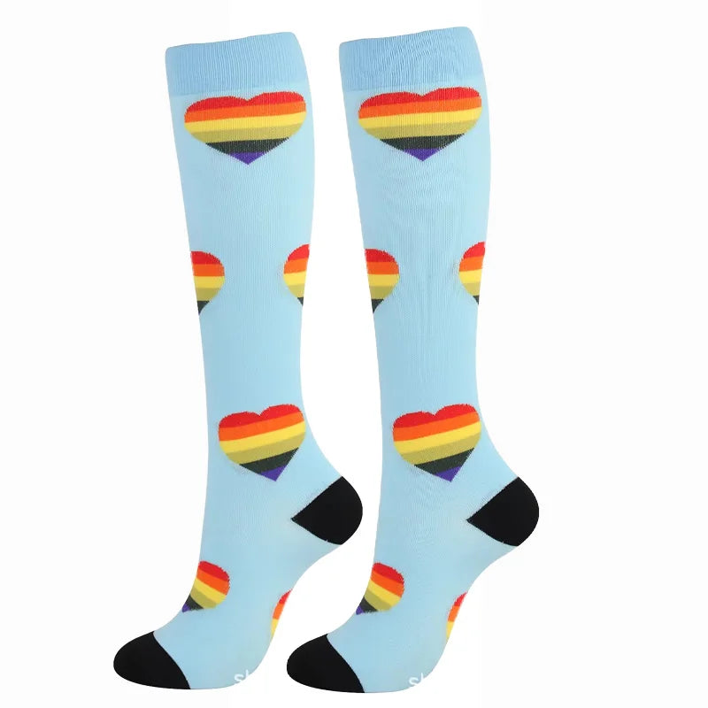 A pair of light blue compression elastic socks featuring multicolored heart patterns.