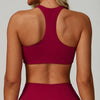 A woman wearing a maroon padded sport yoga bra from the back view.