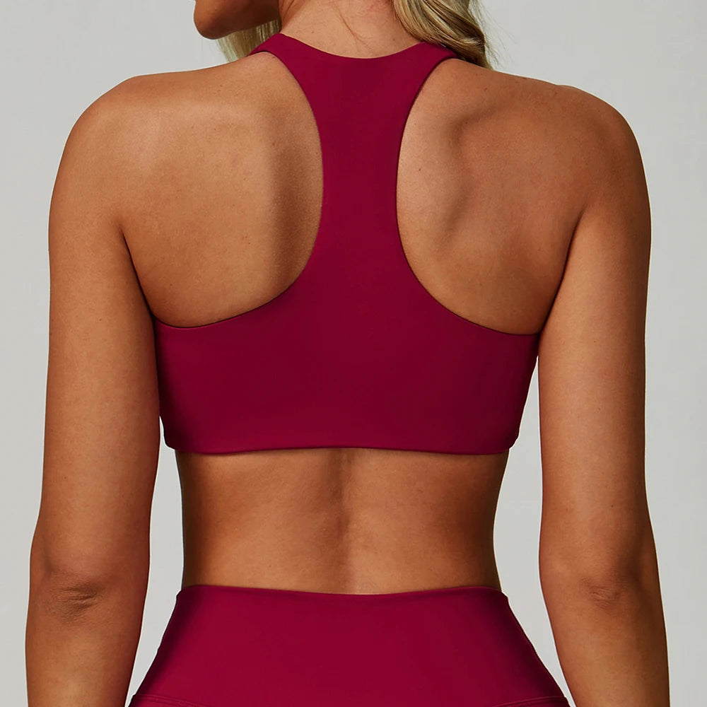 A woman wearing a maroon padded sport yoga bra from the back view.