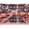 A close-up of a bohemian stretch cotton headband featuring intricate geometric patterns in black, pink, and orange.