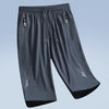 Gray men's quick dry jogging shorts with zippered pockets and a tapered fit