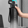 A hand is shown opening the cap of a large capacity sports water bottle, highlighting the mechanism.