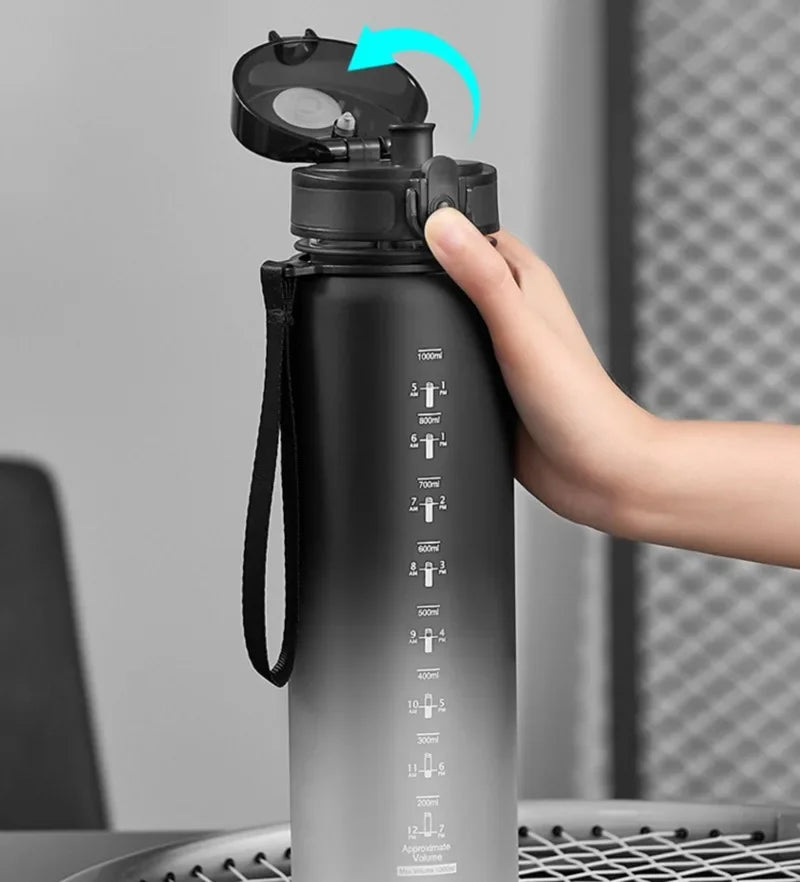 A hand is shown opening the cap of a large capacity sports water bottle, highlighting the mechanism.