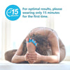 A person is lying down with their feet placed in a silicone toe separator for a foot straightening treatment.