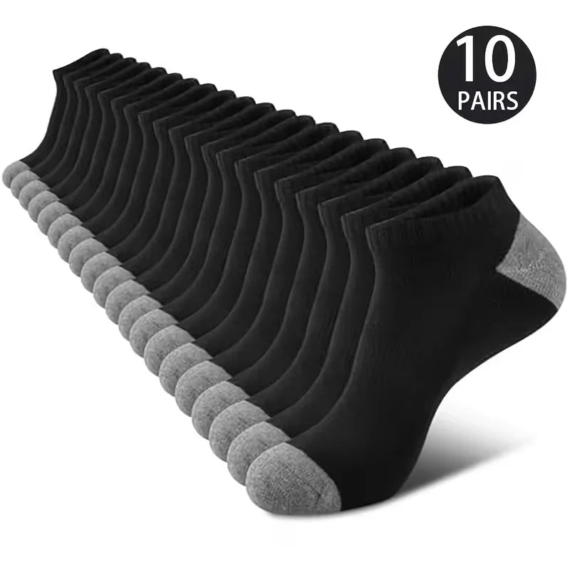 A stack of ten pairs of black and gray comfort fit ankle socks.