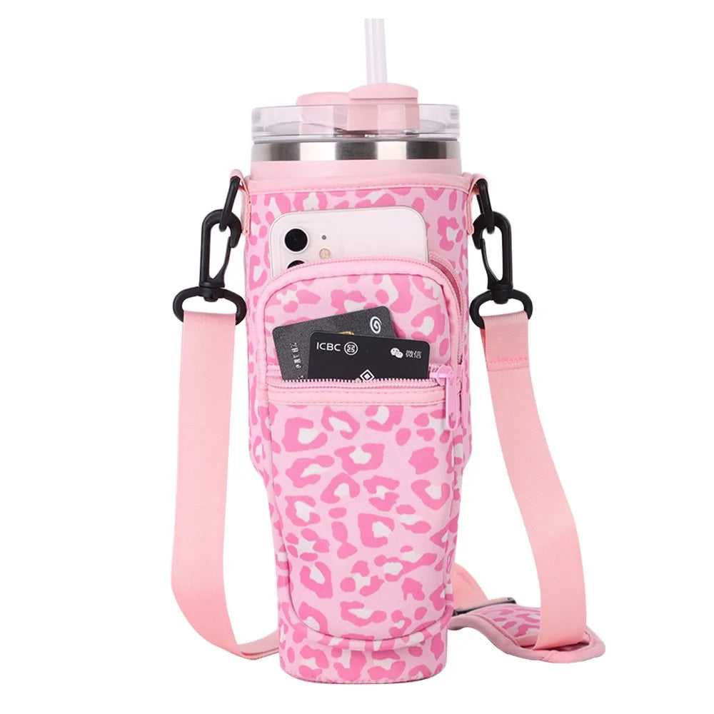 Pink leopard print adjustable pouch for carrying a water bottle with a straw and phone.