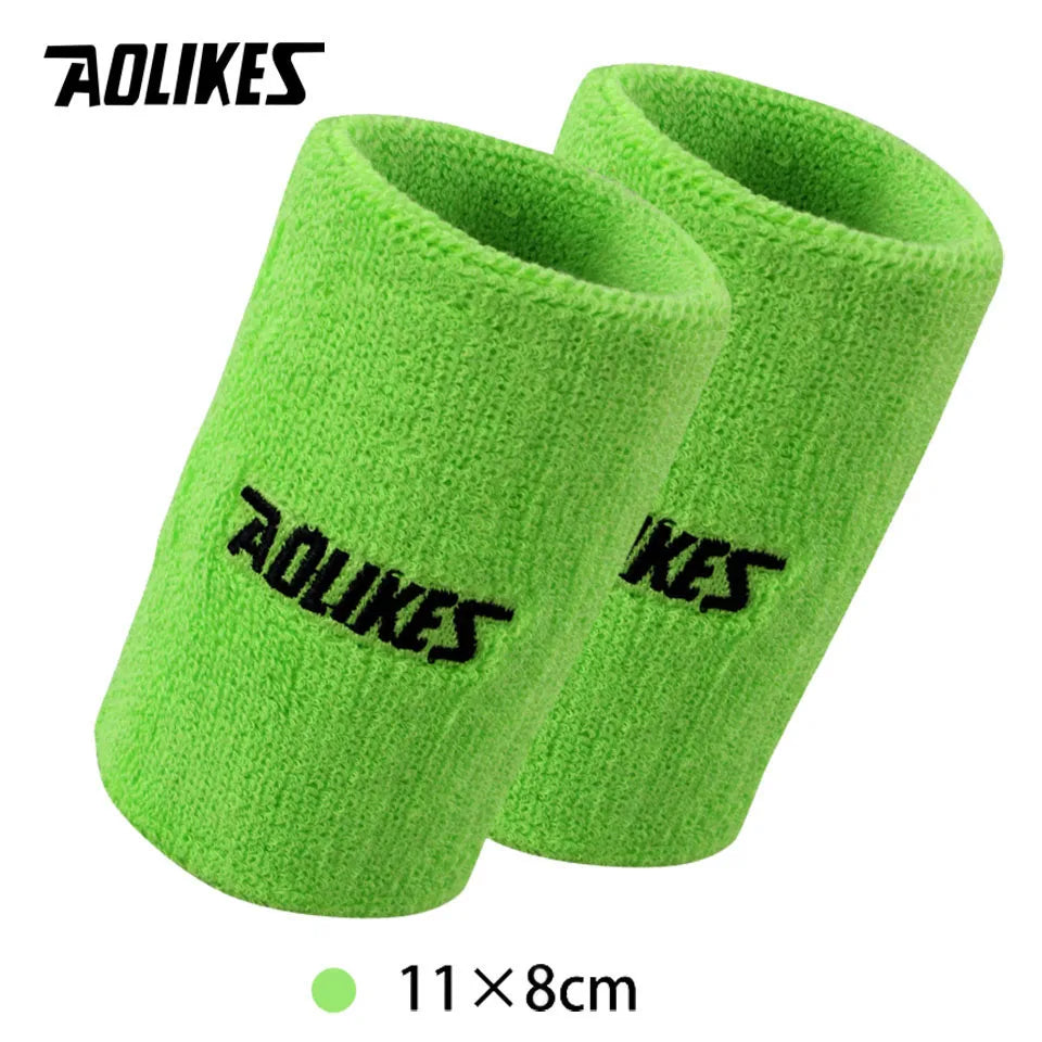 A pair of bright lime green silicone wristbands for sport or activewear