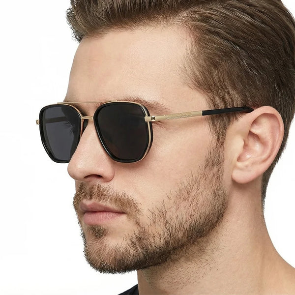 A man wearing classic pilot polarized sunglasses with gold accents and dark lenses.