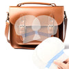 A brown leather cosmetic bag with a flap, showing an invisible body shaping patch.