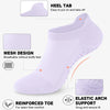A white yoga sock showing features like a heel tab, mesh design, reinforced toe, and elastic arch support.