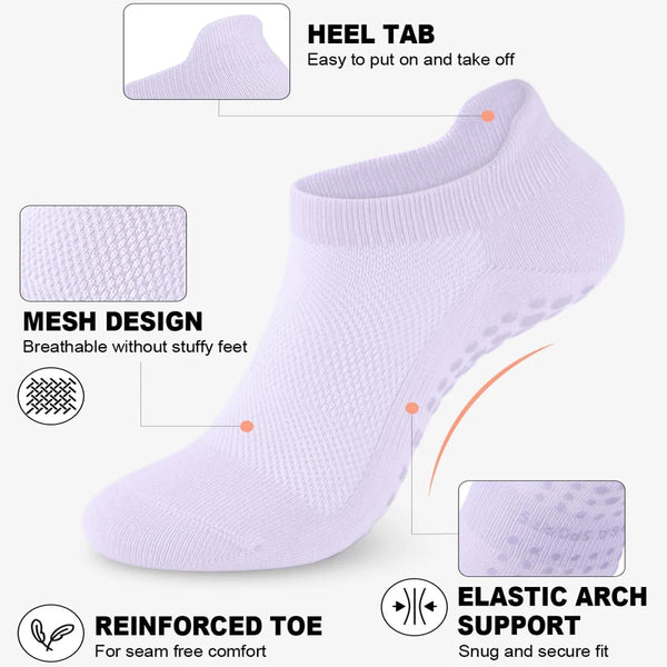 A white yoga sock showing features like a heel tab, mesh design, reinforced toe, and elastic arch support.
